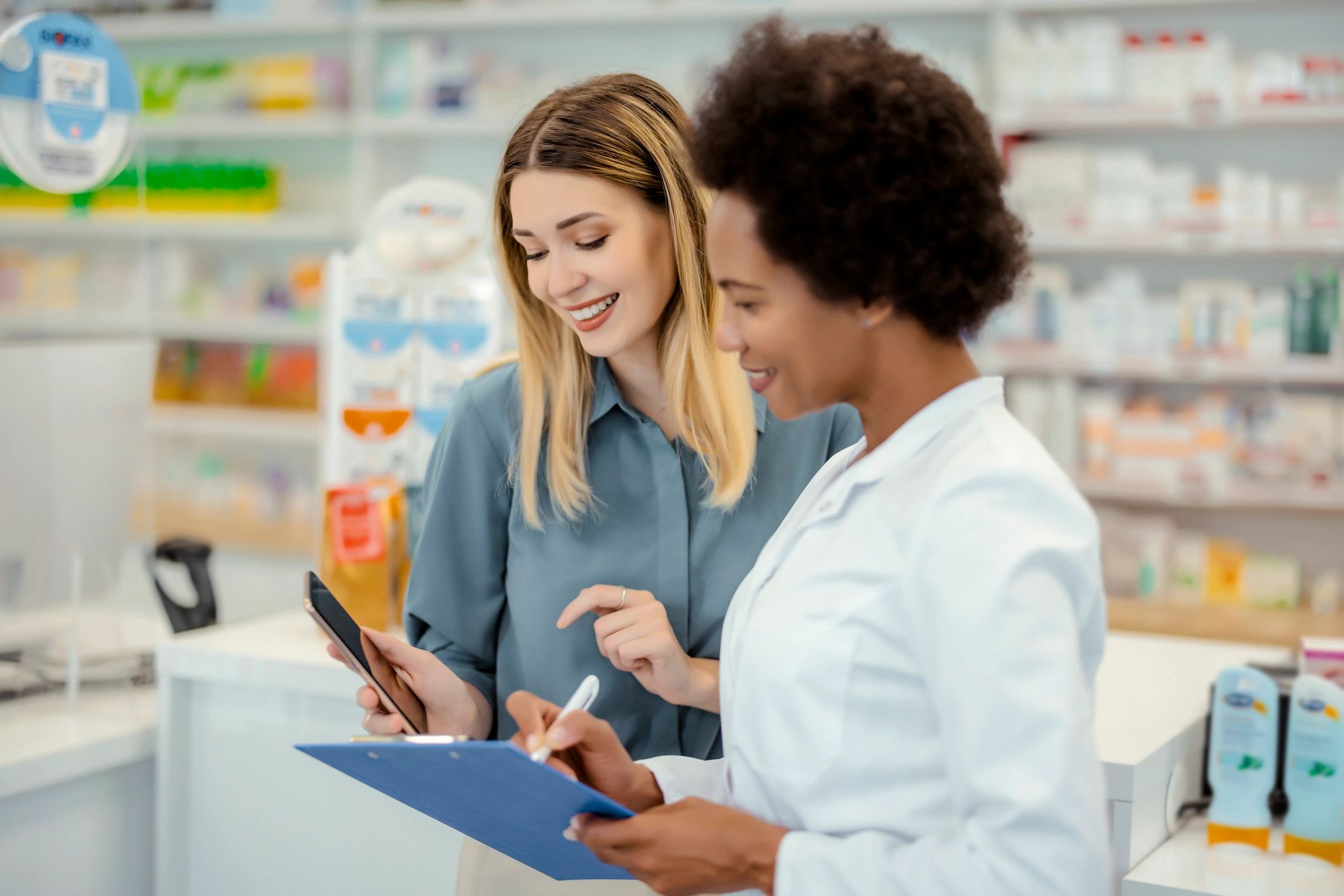 Pharmacist consulting with a customer using a mobile phone