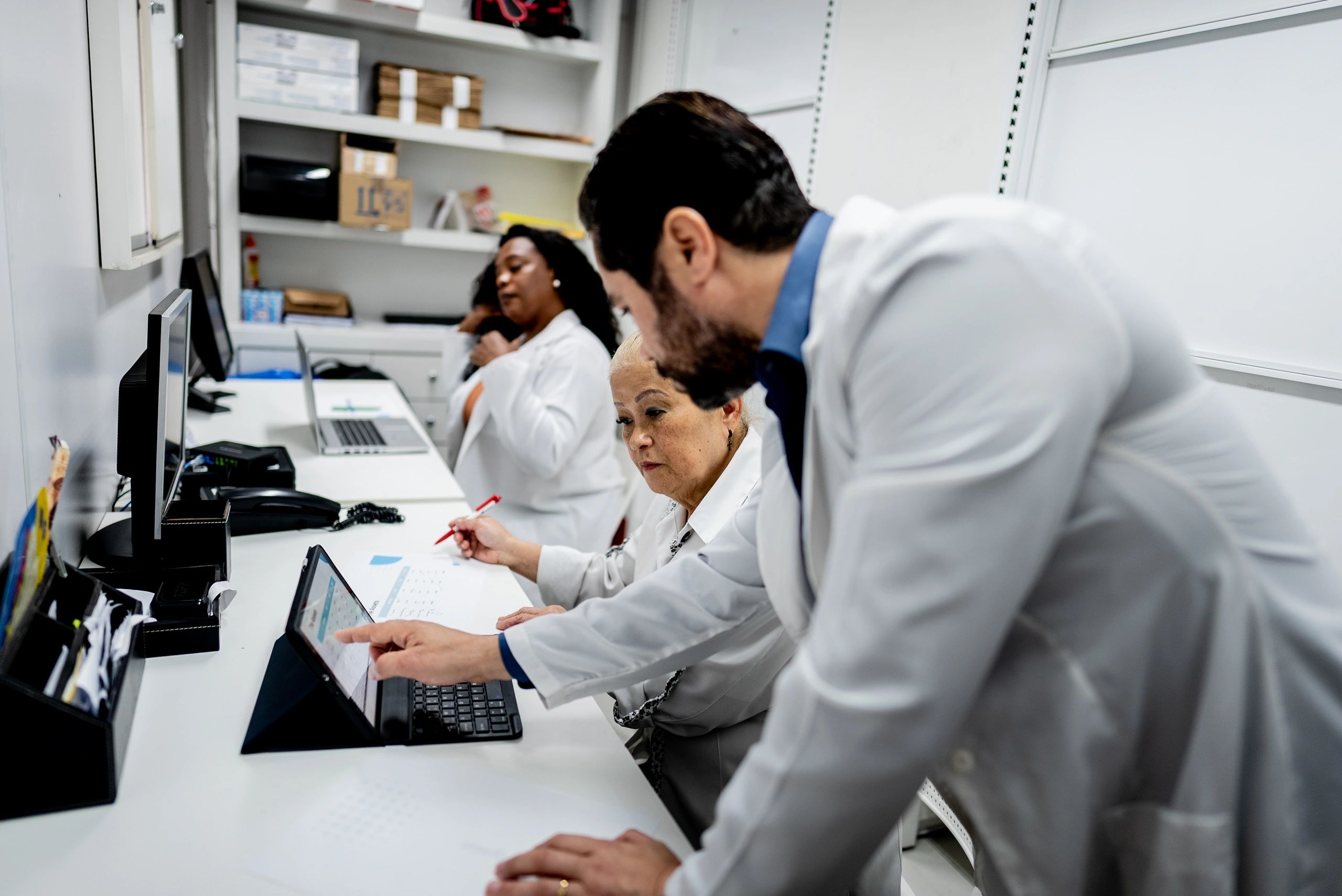 Pharmacy team discussion representing community and care initiatives