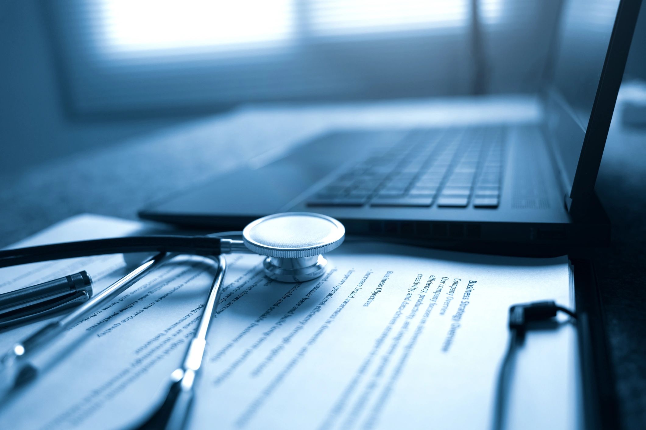 Healthcare compliance documents and tools on a desk